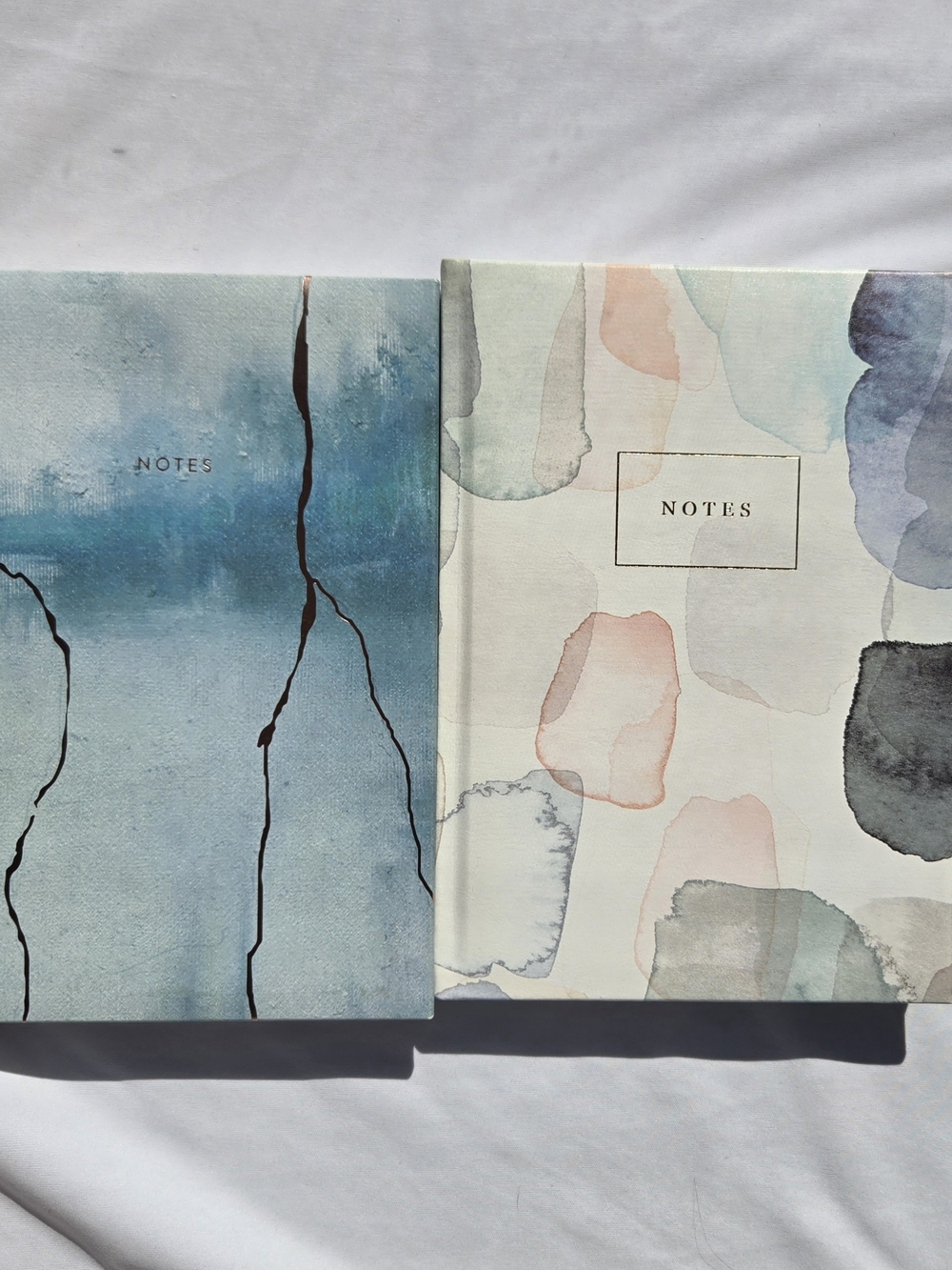 Two Indigo Paper lined notebooks, 10x7 In, padded hardcover, pastel watercolor